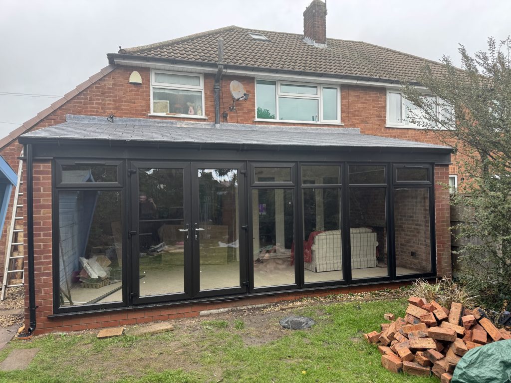 Finished Warmer Roof conservatory with REHAU black uPVC frames in Cheslyn Hay