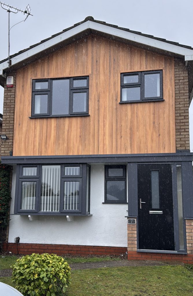 Vertical Fortex 333mm double shiplap cladding in Argyl Brown with slate grey uPVC windows and composite door installed by uPVC Houselift