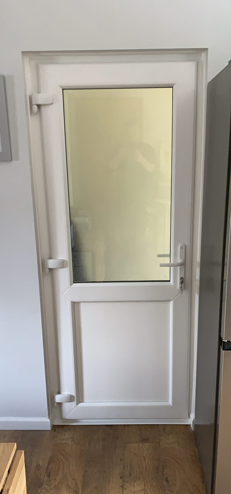 White uPVC back door with obscure glass and a flat panel