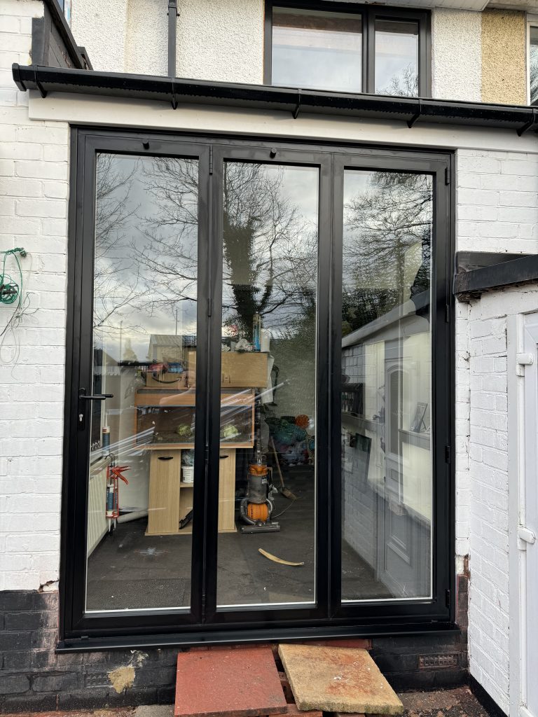 Finished black aluminium bifold doors fitted by uPVC Houselift in Wolverhampton