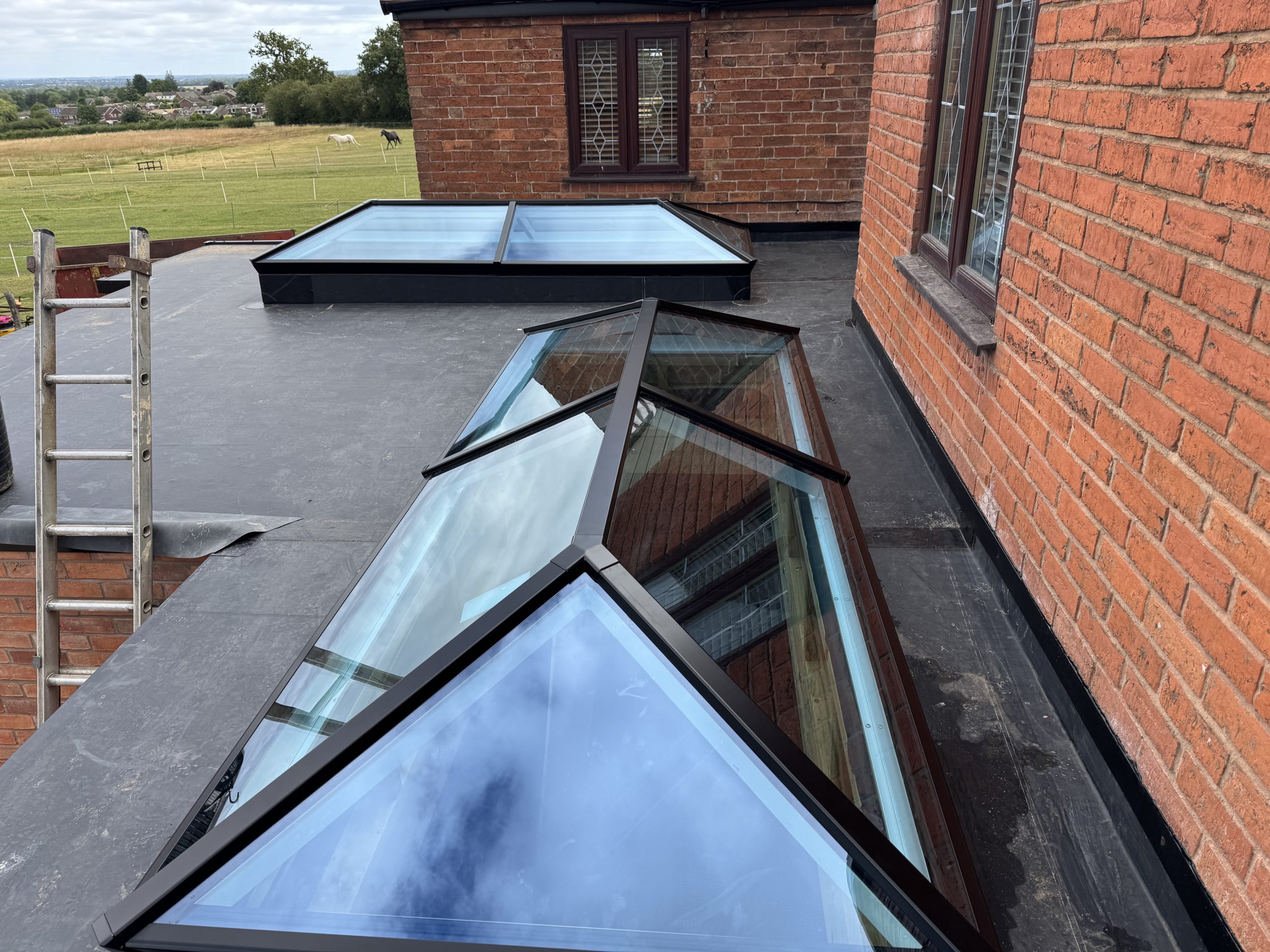 EPDM rubber flat roof with two roof lanterns installed by uPVC Houselift