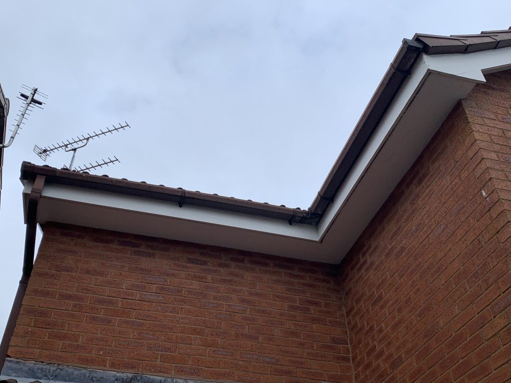 Before roofline with old fascias, soffits and brown guttering before replacement in Perton by uPVC Houselift