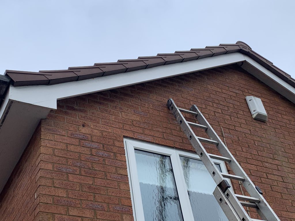 Before roofline replacement showing old fascias, soffits and brown guttering on a house in Perton before installation by uPVC Houselift