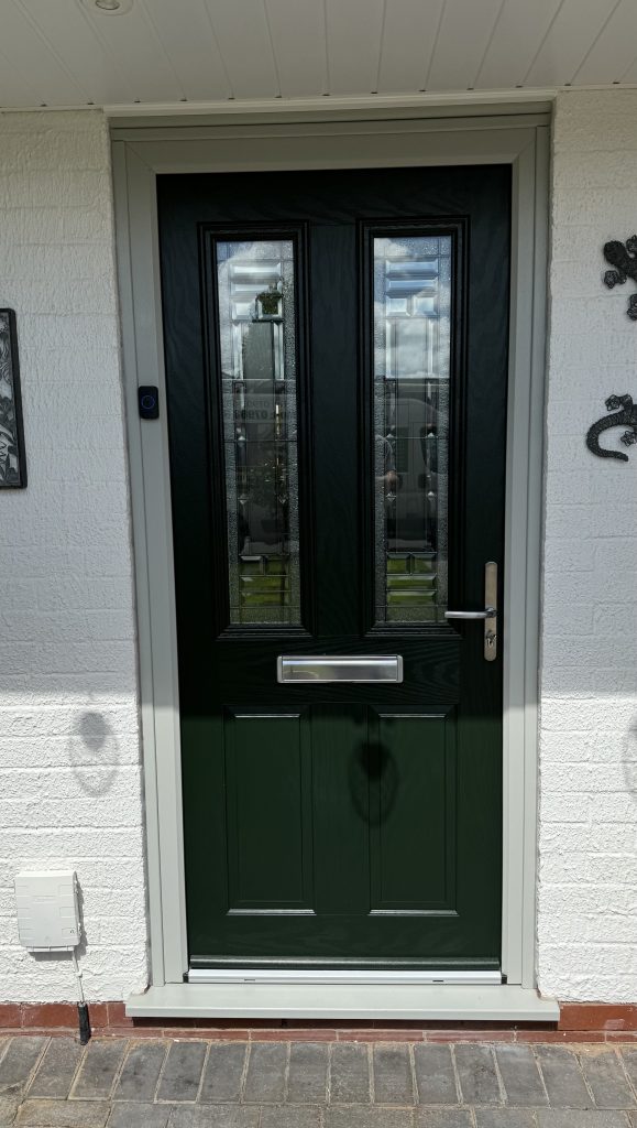 Dark green composite front door with decorative glazed panels installed by uPVC Houselift in Perton