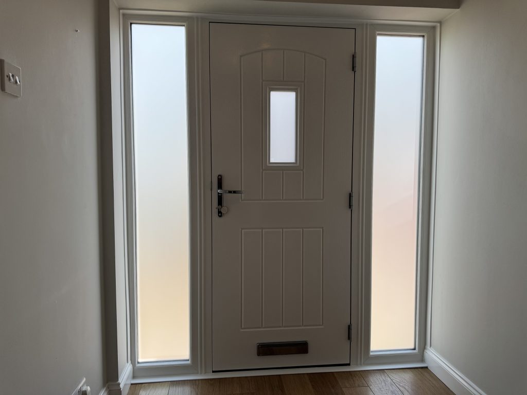 Internal view of new white Rockdoor composite door with matching side frames installed in Highfields Park, Cheslyn Hay by uPVC Houselift