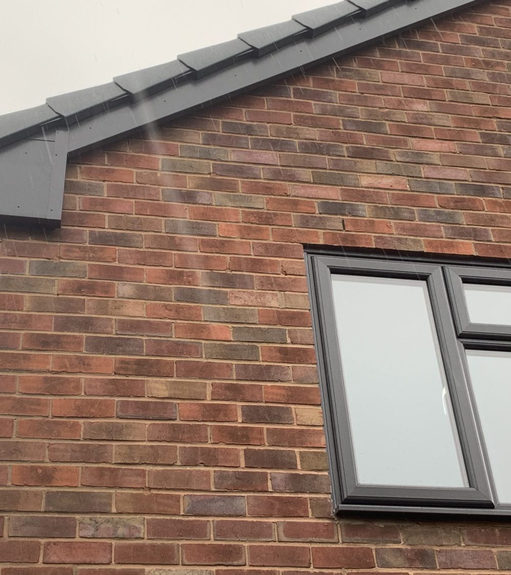 Anthracite grey REHAU uPVC windows with matching anthracite grey fascia, soffits and guttering installed by uPVC Houselift